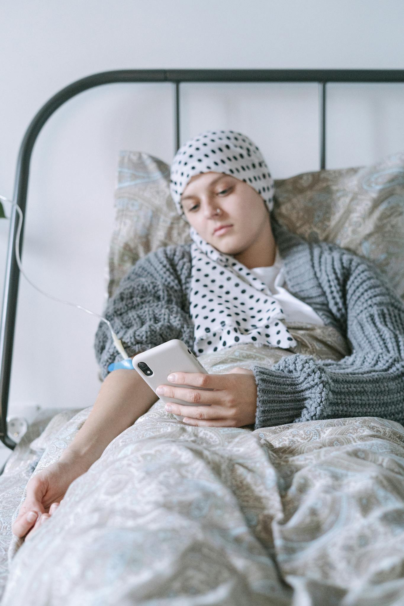 Woman in Gray Sweater and White Hijab Holding Silver Iphone 6